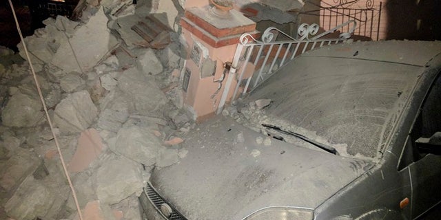 A car lays amid debris following an earthquake in Casamicciola on the Italian resort island of Ischia.