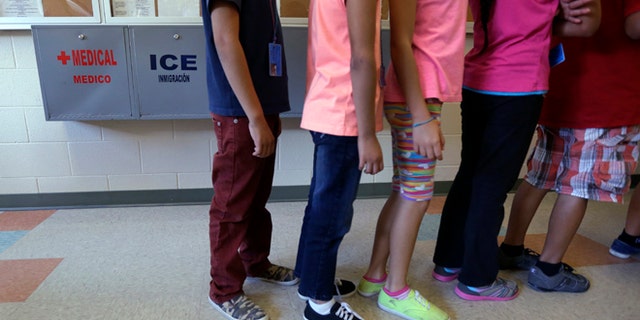 Immigrant children line up in the cafeteria at the Karnes County Residential Center in Karnes City, Texas.