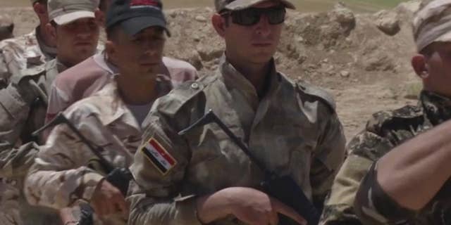 In this video grab made on Tuesday, June 14, 2016, in Alqoosh, Iraq, shows Assyrian Christian militiamen during a training. The group also know as the Nineveh Plain Protection Units, or NPU, are one of three Christian armed groups who are hoping for American support after the U.S. House of Representatives called for direct assistance to be delivered to local security forces in the north of Iraq. (AP Photo/ Balint Szlanko)