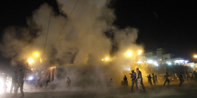 Nov. 21, 2012: People run away after a second blast outside a Shiite mosque during a mourning congregation in Karachi, Pakistan.