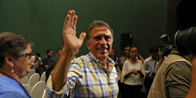 Miguel Angel Yunes waves at supporters as he arrives to give a news conference in Veracruz, Mexico, Sunday, June 5, 2016. Mexico's ruling party appeared to have suffered a series of stinging defeats in the 12 governorships up for grabs in state elections, according to preliminary vote counts Monday. Hobbled by corruption scandals, violence and a weak economy, the ruling Institutional Revolutionary Party lost four states including Veracruz, a state of 8 million that is the third most-populous in the country. (AP Photo/Ilse Huesca)