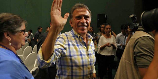 Miguel Angel Yunes waves at supporters as he arrives to give a news conference in Veracruz, Mexico, Sunday, June 5, 2016. Mexico's ruling party appeared to have suffered a series of stinging defeats in the 12 governorships up for grabs in state elections, according to preliminary vote counts Monday. Hobbled by corruption scandals, violence and a weak economy, the ruling Institutional Revolutionary Party lost four states including Veracruz, a state of 8 million that is the third most-populous in the country. (AP Photo/Ilse Huesca)