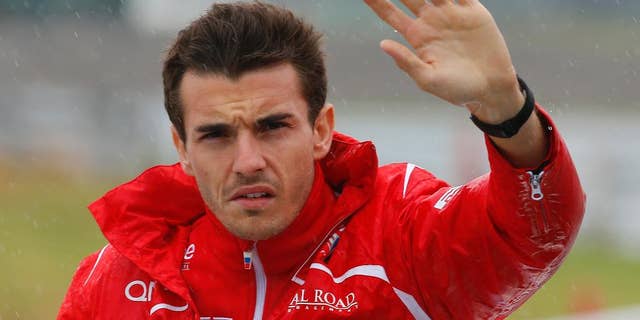 Marussia driver Jules Bianchi of France waves during drivers' parade before the Japanese Formula One Grand Prix at the Suzuka Circuit in Suzuka, central Japan, Sunday, Oct. 5, 2014. Bianchi has been taken to hospital and is unconscious following a crash during the Japanese Grand Prix. The race was red-flagged with nine laps to go after Bianchi went off at Turn 7, where Sauber's Adrian Sutil had crashed earlier. (AP Photo/Shizuo Kambayashi)