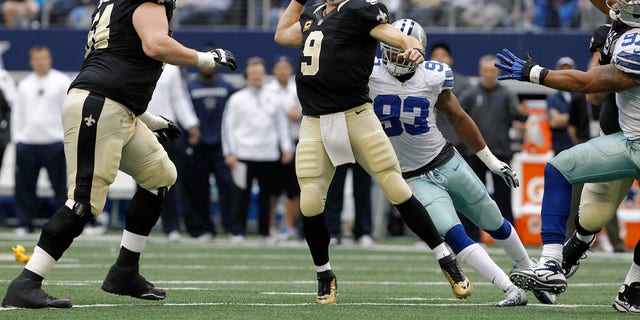 New Orleans Saints quarterback Drew Brees, #9, passes the ball during the first half of an NFL football game on Sunday, December 23, 2012, in Arlington, Texas, against the Dallas Cowboys.