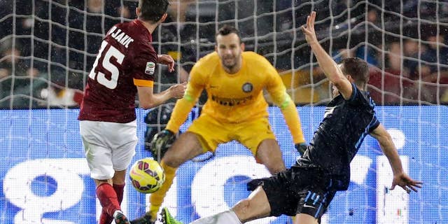 Roma's Miralem Pjanic, left, scores during a Serie A soccer match between Roma and Inter Milan at Rome's Olympic Stadium, Sunday, Nov. 30, 2014. (AP Photo/Andrew Medichini)
