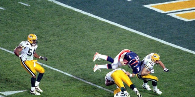 Denver quarterback John Elway goes airborne to pick up a first down in Super Bowl XXXII at Qualcomm Stadium in San Diego, CA. The Broncos defeated the Green Bay Packers 31-24 on 1/25/1998. (Photo by Kevin Reece/Getty Images)
