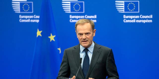 FILE- In this Wednesday, Nov. 9, 2016 file photo, European Council President Donald Tusk reads a statement during a media conference at the EU Council building in Brussels. Tusk says he thinks the European Union will extend sanctions against Russia, but that it will be harder to preserve the West's unity on Moscow when Donald Trump is U.S. president. (AP Photo/Virginia Mayo, File)