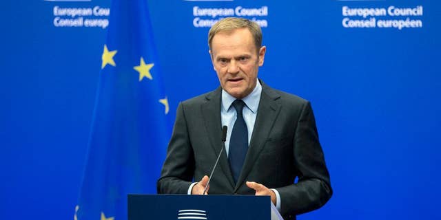 FILE- In this Wednesday, Nov. 9, 2016 file photo, European Council President Donald Tusk reads a statement during a media conference at the EU Council building in Brussels. Tusk says he thinks the European Union will extend sanctions against Russia, but that it will be harder to preserve the West's unity on Moscow when Donald Trump is U.S. president. (AP Photo/Virginia Mayo, File)