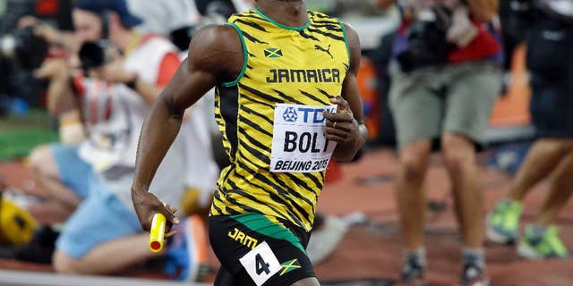 Jamaica's Usain Bolt celebrates after anchoring the team to the gold medal in the men's 4x100m relay at the World Athletics Championships at the Bird's Nest stadium in Beijing, Saturday, Aug. 29, 2015. 