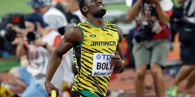 Jamaica's Usain Bolt celebrates after anchoring the team to the gold medal in the men's 4x100m relay at the World Athletics Championships at the Bird's Nest stadium in Beijing, Saturday, Aug. 29, 2015.
