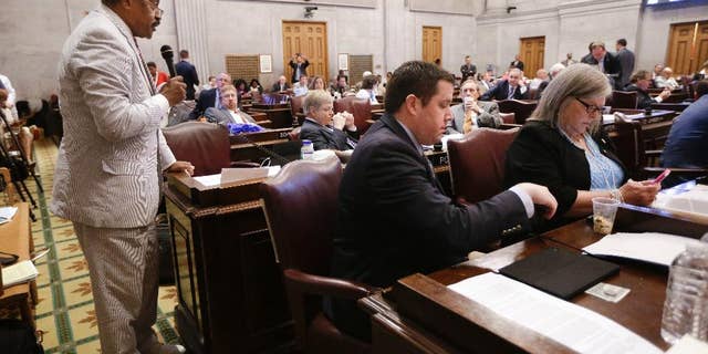 Rep. John DeBerry, D-Memphis, left, speaks during the debate to override Gov. Bill Haslam's veto of a bill seeking to make the Bible the state's official book, Wednesday, April 20, 2016, in Nashville, Tenn. The House voted not to override the veto. (AP Photo/Mark Humphrey)