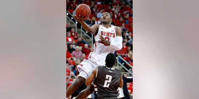 North Carolina State's Rodney Purvis (0) drives to the basket over St. Bonaventure's Eric Mosley (2) during the first half of an NCAA college basketball game in Raleigh, N.C., Saturday, Dec. 22, 2012. (AP Photo/Karl B DeBlaker)