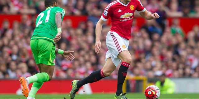 FILE - This is a Saturday, Sept. 26, 2015  file photo of Manchester United's Michael Carrick, right, as he fights for the ball against Sunderland's Yann M'Vila during the English Premier League soccer match between Manchester United and Sunderland at Old Trafford Stadium, Manchester, England.  Amid the likely rotation during the 2016 busy festive program in the Premier League, there’s one player Manchester United fans won’t want to see out of the team and that player is Michael Carrick (AP Photo/Jon Super, File)