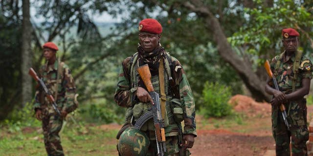 Troops from the Central African Republic stand guard in April 2012 at a building used for joint meetings between them and U.S. Army special forces, in Obo, Central African Republic, where U.S. special forces have paired up with local troops and Ugandan soldiers to seek out Joseph Kony's Lord's Resistance Army (LRA). AA rebel in charge of communications for warlord Joseph Kony has surrendered to Ugandan forces, the military said on March 30, 2017, shortly after the U.S. indicated it was pulling out of the international manhunt for one of Africa's most notorious fugitives. (AP Photo/Ben Curtis, File)
