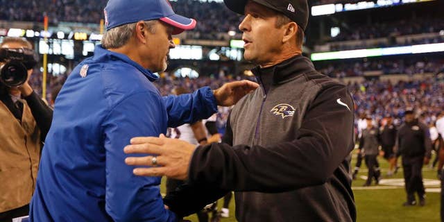 Indianapolis Colts head coach Chuck Pagano, left, greets Baltimore Ravens head coach John Harbaugh following an NFL football game in Indianapolis, Sunday, Oct. 5, 2014. The Colts defeated the Ravens 20-13. (AP Photo/Jeff Roberson)