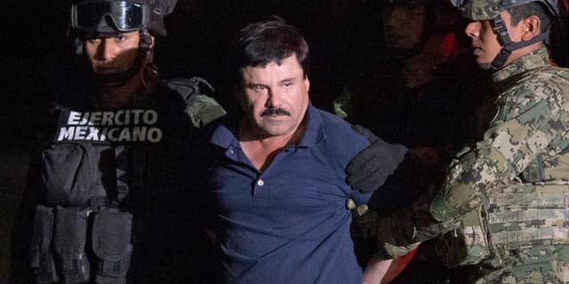 FILE - In this Jan. 8, 2016 file photo, Mexican drug lord Joaquin "El Chapo" Guzman is escorted by soldiers to a waiting helicopter at a federal hangar in Mexico City, after he was recaptured from breaking out of a maximum security prison in Mexico. A Mexican judge said on Monday, May 9, 2016 that Guzman's extradition to the U.S. can move ahead, but the country’s foreign ministry must still approve it and the defense can appeal. (AP Photo/Rebecca Blackwell, File)