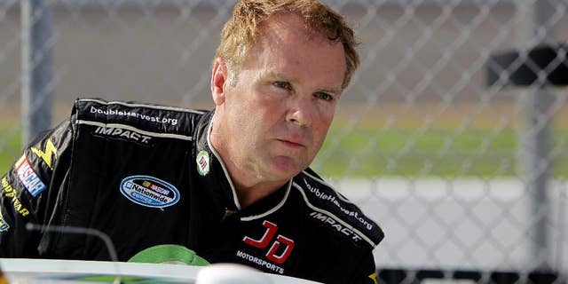 FILE - In this Feb. 19, 2012, file photo, NASCAR driver Mike Wallace climbs out of his car after his attempt at qualifying for the Daytona 500 auto race at Daytona International Speedway, in Daytona Beach, Fla. Wallace says he and his daughter were attacked after a Rascal Flatts concert in North Carolina. Charlotte-Mecklenburg police told local media three men have been arrested after the attack Friday night, June 17, 2016, at the PNC Music Pavilion in Charlotte. (AP Photo/John Raoux, File)