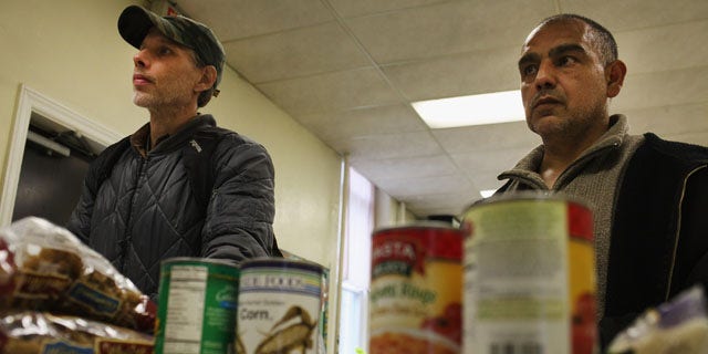 READING, PA - OCTOBER 19:  Men wait for groceries at the Central Park United Methodist Church weekly food pantry on October 19, 2011 in Reading, Pennsylvania. The U.S. Census says in a report released Nov. 7, 2011, that 28 percent of Latinos across the country live below the poverty line.  (Photo by Spencer Platt/Getty Images)