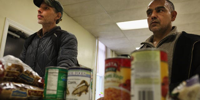 READING, PA - OCTOBER 19: Men wait for groceries at the Central Park United Methodist Church weekly food pantry on October 19, 2011 in Reading, Pennsylvania. The U.S. Census says in a report released Nov. 7, 2011, that 28 percent of Latinos across the country live below the poverty line. (Photo by Spencer Platt/Getty Images)