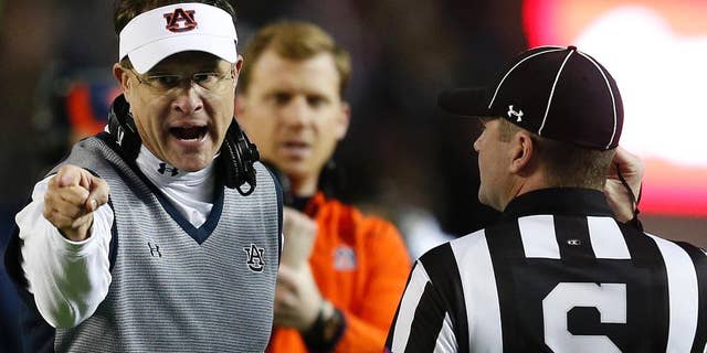 Auburn head coach Gus Malzahn speaks to official during the second half of the Iron Bowl NCAA college football game against Alabama, Saturday, Nov. 29, 2014, in Tuscaloosa, Ala. Alabama won 55-44. (AP Photo/Butch Dill)