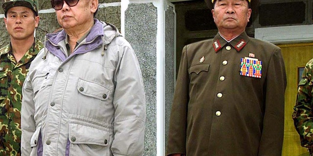 FILE - In this April 23, 2007 file photo released by Korean Central News Agency via Korea News Service in Tokyo, Gen. Kim Kyok Sik, right, stands with then-North Korean leader Kim Jong Il during the leader's inspection of Korean People's Army Unit 1637 at an undisclosed location in North Korea. North Korea replaced hard-line defense chief Kim Kyok Sik with little-known army general Jang Jong Nam. Mention of Jang's new role was buried Monday, May 13, 2013 in a state media dispatch listing those who attended an art performance with leader Kim Jong Un. (AP Photo/Korean Central News Agency via Korea News Service, File)