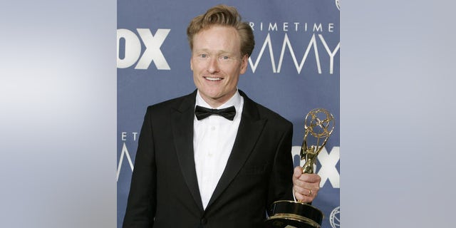 Conan O'Brien holds the awards for outstanding writing for a variety, music or comedy program for "Late Night with Conan O'Brien" the 59th Primetime Emmy Awards Sunday, Sept. 16, 2007, in Los Angeles. (AP Photo/Chris Carlson)