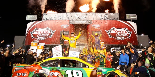 Kyle Busch, center, celebrates in Victory Lane after winning the NASCAR Cup Series auto race at Richmond Raceway in Richmond, Va., Saturday, April 21, 2018. (AP Photo/Steve Helber)