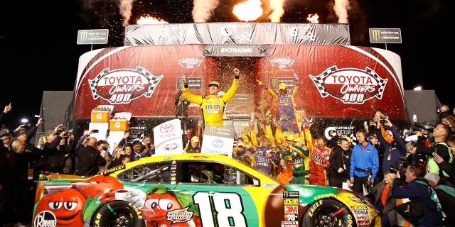 Kyle Busch, center, celebrates in Victory Lane after winning the NASCAR Cup Series auto race at Richmond Raceway in Richmond, Va., Saturday, April 21, 2018. (AP Photo/Steve Helber)
