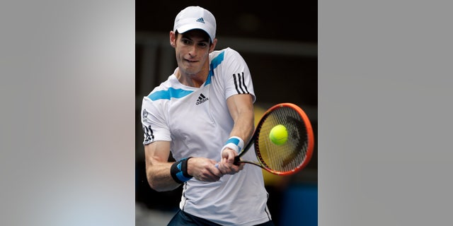 Andy Murray of Britain makes a backhand return to Stephane Robert of France during their fourth round match at the Australian Open tennis championship in Melbourne, Australia, Monday, Jan. 20, 2014.(AP Photo/Rick Rycroft)