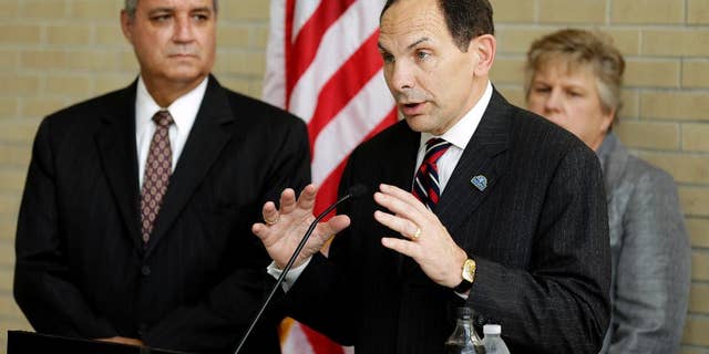 FILE - In this Oct. 1, 2014 file photo, Veterans Affairs Secretary Robert McDonald, center, accompanied by House Veterans Affairs Committee Chairman Rep. Jeff Miller, left, R-Fla., left, and Kathleen Fogarty, Director of the James A. Haley Medical Center, speaks at the James A. Haley Medical Center in Tampa, Fla. The Republican-led House is moving ahead on a bill aimed at making it easier for the Department of Veterans Affairs to fire employees for misconduct or poor performance, a source of ongoing tension with the Obama administration. (AP Photo/Chris O'Meara, File)