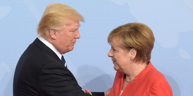 U.S. President Donald Trump, left, is welcomed by German Chancellor Angela Merkel on the first day of the G-20 summit in Hamburg, northern Germany, Friday, July 7, 2017. (Associated Press)