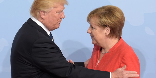 U.S. President Donald Trump, left, is welcomed by German Chancellor Angela Merkel on the first day of the G-20 summit in Hamburg, northern Germany, Friday, July 7, 2017. (Associated Press)