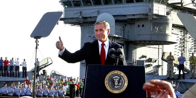 Former President George W. Bush declares the end of major combat operations in Iraq aboard aircraft carrier USS Abraham Lincoln. The war appeared at the time to be a success, but later, as conditions in Iraq deteriorated, the message of "mission accomplished" was criticized as premature.