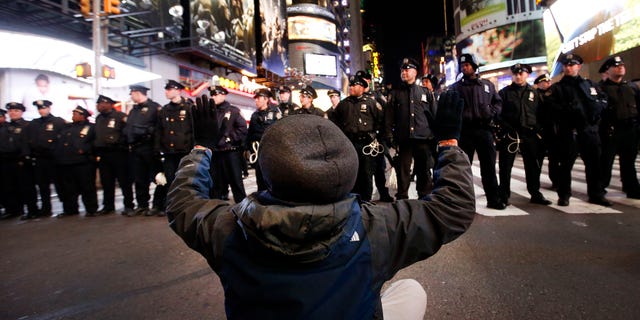 A protester on 42nd Street near Times Square, Thursday, Dec. 4, 2014, in New York.