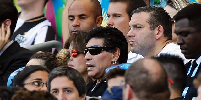 Argentine soccer legend Diego Maradona watches the group F World Cup soccer match between Argentina and Iran at the Mineirao Stadium in Belo Horizonte, Brazil, Saturday, June 21, 2014. (AP Photo/Victor R. Caivano)