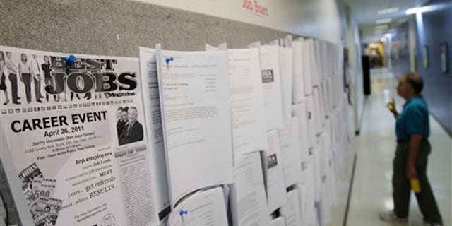 April 1: An unemployed man looks at job listings in Menlo Park, Calif.