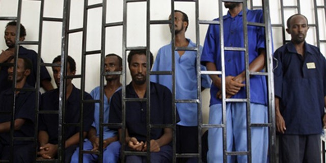 July 15, 2009: Suspected Somali pirates appear behind bars of a court in Yemen's southern port city of Aden. Worldwide piracy figures have reached a five-year low, according to the International Maritime Bureau. (Reuters)