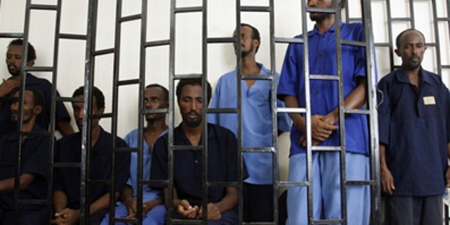 July 15, 2009: Suspected Somali pirates appear behind bars of a court in Yemen's southern port city of Aden. Worldwide piracy figures have reached a five-year low, according to the International Maritime Bureau. (Reuters)