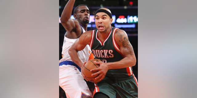 Milwaukee Bucks guard Jerryd Bayless (19) drives past New York Knicks guard Tim Hardaway Jr. in the second half of their preseason NBA basketball game at Madison Square Garden, Monday, Oct. 20, 2014, in New York. The Bucks won, 120-107. (AP Photo/John Minchillo)