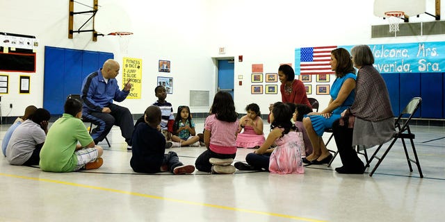 SILVER SPRING, MD - MAY 19:  U.S. first lady Michelle Obama (3rd R) and her Mexican counterpart Margarita Zavala (2nd R) listen to PE teacher Thomas Ryan (L) during a physical education class as they visit New Hampshire Estates Elementary School,  which was awarded the USDA?s Healthier US School Challenge Silver Award in 2009 and partnered with a school in Mexico as part of the Monarch Butterfly Sister School Program,  May 19, 2010 in Silver Spring, Maryland. President of Mexico Felipe Calderon is on a state visit to Washington with the first lady of Mexico.  (Photo by Alex Wong/Getty Images)