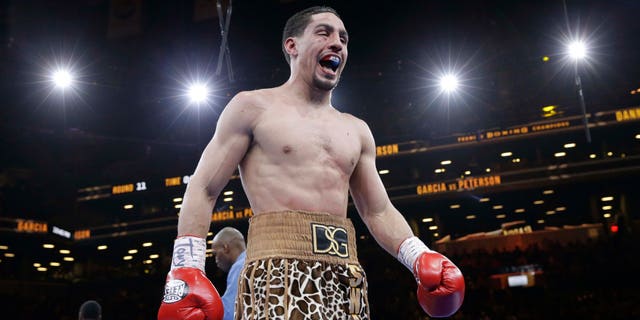 Danny Garcia reacts while returning to his corner after the 11th round during a super lightweight boxing match against Lamont Peterson, Saturday, April 11, 2015, in New York. Garcia won by a majority decision. (AP Photo/Mary Altaffer)