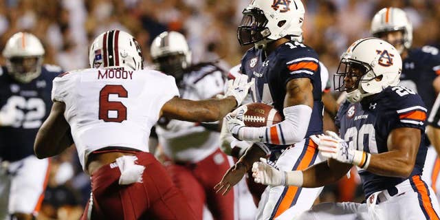 Auburn quarterback Nick Marshall (14) runs the ball in for a touchdown against South Carolina during the second half of an NCAA college football game Saturday, Oct. 25, 2014, in Auburn, Ala. Auburn won 42-35. (AP Photo/Brynn Anderson)