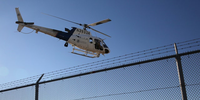 SAN DIEGO, CA - OCTOBER 01: A U.S. Office of Air and Marine (OAM) helicopter patrols near the U.S.-Mexico border on October 1, 2013 in San Diego, California. OAM helicopters support U.S. Border Patrol as well as Immigration and Customs Enforcement (ICE), personnel protecting border areas. While much of the Federal Government has closed down, personnel considered essential, such as border agents, remain working. (Photo by John Moore/Getty Images)