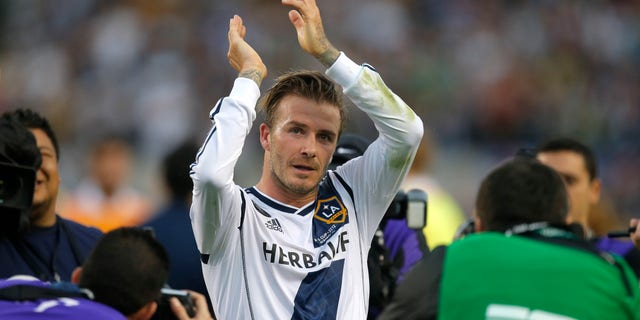 FILE - In this Saturday, Dec. 1, 2012 file photo Los Angeles Galaxy's David Beckham, of England, acknowledges the fans as he leaves the field after the team's 3-1 win in the MLS Cup championship soccer match against the Houston Dynamo in Carson, Calif. According to reports Thursday Jan. 31, 2013, David Beckham is to join Paris Saint-Germain. (AP Photo/Jae C. Hong, File)