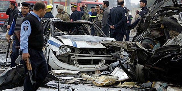 Dec. 8: Iraqi security forces gather at the site of a bomb attack near the Labor Ministry building in Baghdad.