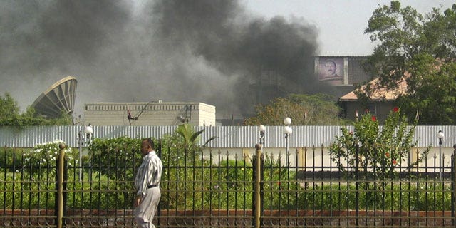 June 19: Black smoke is seen coming from the intelligence services building that came under attack in the southern port city of Aden, about 200 miles south of the capital, San'a, in Yemen.