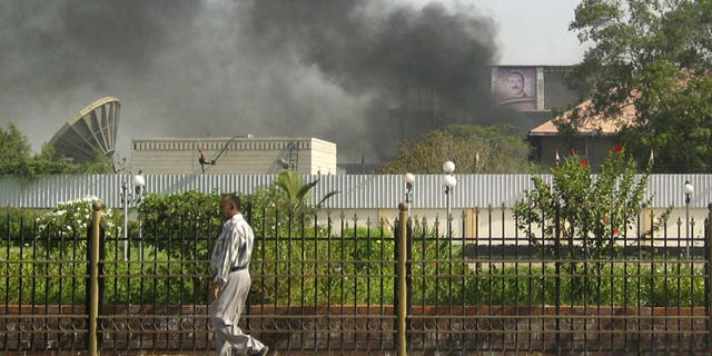 June 19: Black smoke is seen coming from the intelligence services building that came under attack in the southern port city of Aden, about 200 miles south of the capital, San'a, in Yemen.