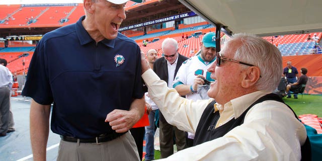 In this Sunday, Dec. 16, 2012, photo, Miami Dolphins coach Joe Philbin, left, and former coach Don Shula speak before an NFL football game, Sunday, Dec. 16, 2012, in Miami. Shula is optimistic Philbin and rookie Ryan Tannehill will put an end to years of steady turnover at the head coach and quarterback positions. (AP Photo/Wilfredo Lee)