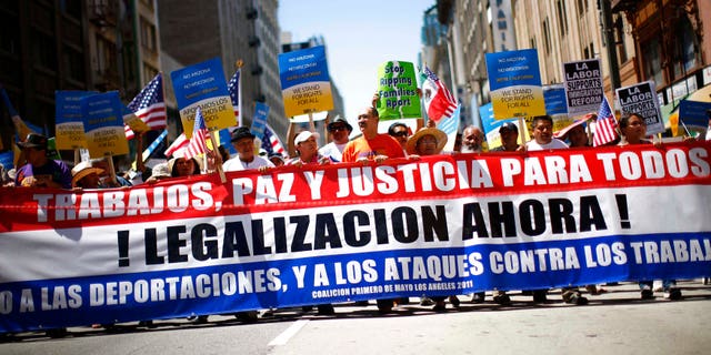 LOS ANGELES, CA - MAY 1: Demonstrators march during a May Day protest May 1, 2011 in Los Angeles, California. Thousands of people marched for immigration reform, among other issues. (Photo by Eric Thayer/Getty Images)
