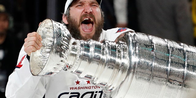Washington Capitals left wing Alex Ovechkin, of Russia, hoists the Stanley Cup after the Capitals defeated the Golden Knights in Game 5 of the NHL hockey Stanley Cup Finals Thursday, June 7, 2018, in Las Vegas. (AP Photo/John Locher)